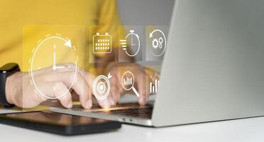 Time management concept. Businessman touching clock icon on virtual to work planning photo