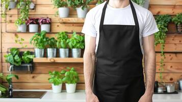 Man wearing black apron mock up in the modern kitchen, chef uniform for cooking photo