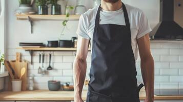Man wearing black apron mock up in the modern kitchen, chef uniform for cooking photo