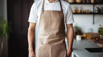 Man wearing beige linen apron mock up in the modern kitchen, chef uniform for cooking photo