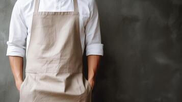 Man wearing beige linen apron mock up in the modern kitchen, chef uniform for cooking photo