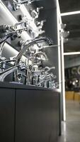 Exhibition showcase in store with faucets for the kitchen and bathroom. Vertical video