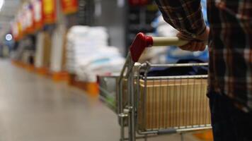 Customer walking with trolley in hardware store video