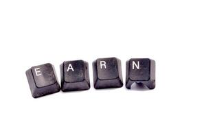 Word writing text Earn. Business concept. Dirty used eyboard buttons on white background photo