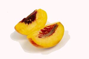 Beautiful peach slices isolated on white background photo