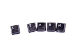 Word writing text Learn. Business concept. Dirty used eyboard buttons on white background. photo