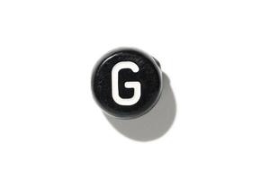 Vintage typewriter key with letter g on white background - minimalistic retro design element for creative projects photo