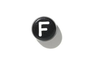 Single black keyboard key with letter f on white background for minimalist tech design aesthetic photo