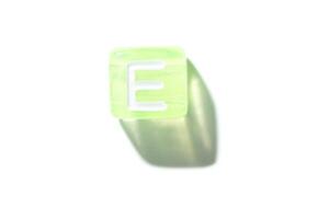 Translucent green cube with letter e casting shadow on white background. photo