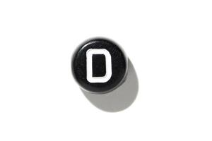 Close-up of vintage typewriter key with shadow on white background. photo