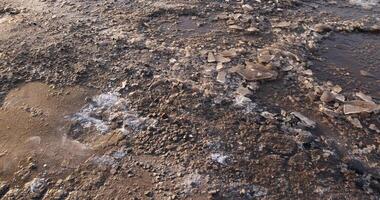a large number of holes and dirt on the highway in winter photo