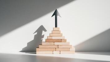 A wooden block with an arrow pointing up on top of it photo