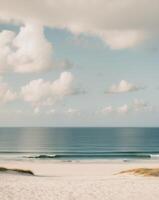 A beach with a surfboard and a person standing on the sand photo