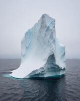 An iceberg floating in the ocean photo
