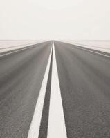 Empty road with white lines on the horizon photo