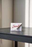 Secret envelope on table with blurred background photo