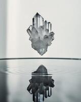 A crystal floating in water with reflection photo