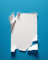 A torn piece of paper with jagged edges sits on a blue background. photo