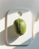 Aerial view of cut green net melon on a cutting board. photo