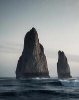 Dark Ocean Scene with Towering Rock Formations. photo
