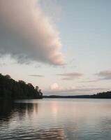 A lake with a cloudy sky and trees in the background photo