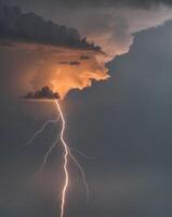 Lightning bolt striking through the clouds photo