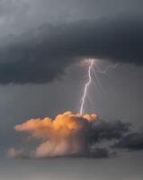 A lightning bolt is seen through the clouds photo