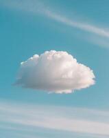 A cloud is floating in the sky above a field photo