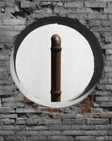 A brick wall with a round hole in it photo