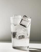 A glass of water with ice cubes in it photo