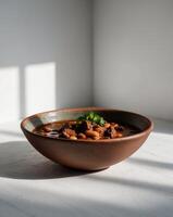 A bowl of chili and beans on a table photo