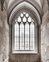 A large window in a stone building with a stone floor photo