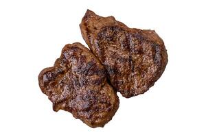 Juicy beef steak grilled with salt, spices and herbs photo