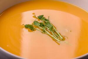 Cream soup of pumpkin, zucchini and carrots with salt and spices photo