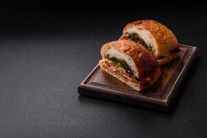 Ciabata with jamon or prosciutto, tomatoes, cheese and lettuce photo