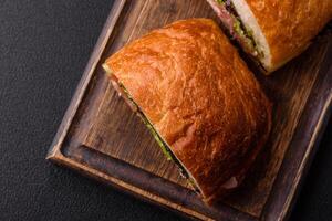 Ciabata with jamon or prosciutto, tomatoes, cheese and lettuce photo