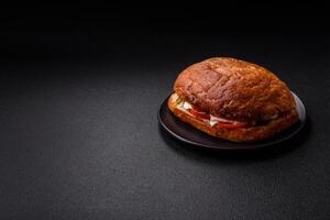 Ciabata with jamon or prosciutto, tomatoes, cheese and lettuce photo
