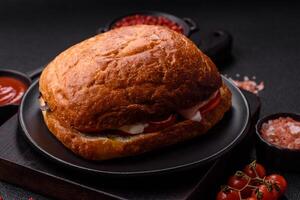 Ciabata with jamon or prosciutto, tomatoes, cheese and lettuce photo