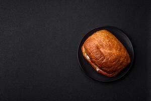 Ciabata with jamon or prosciutto, tomatoes, cheese and lettuce photo