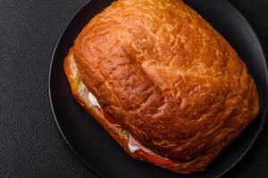 Ciabata with jamon or prosciutto, tomatoes, cheese and lettuce photo