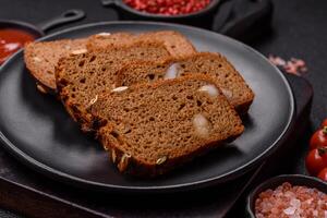 Brown bread with seeds, grains, salt and spices photo