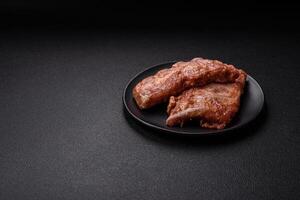 Pork ribs in sweet and sour sauce with salt and spices photo