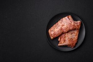 Pork ribs in sweet and sour sauce with salt and spices photo