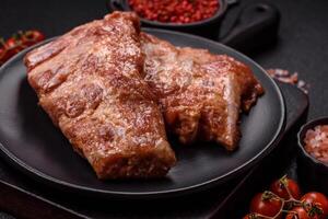 Pork ribs in sweet and sour sauce with salt and spices photo