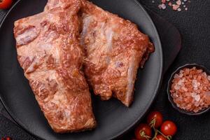 Pork ribs in sweet and sour sauce with salt and spices photo