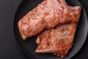 Pork ribs in sweet and sour sauce with salt and spices photo