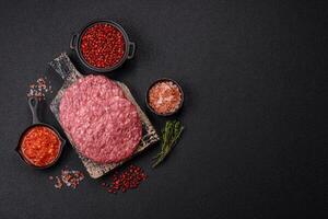 Fresh raw ground beef burger patty with salt and spices photo