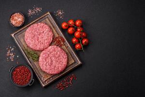 Fresh raw ground beef burger patty with salt and spices photo
