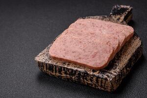 Delicious canned pink spiced ham or spam with salt, spices and herbs photo