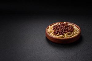 Rice noodles with beans, meat, tomato sauce, spices and herbs photo